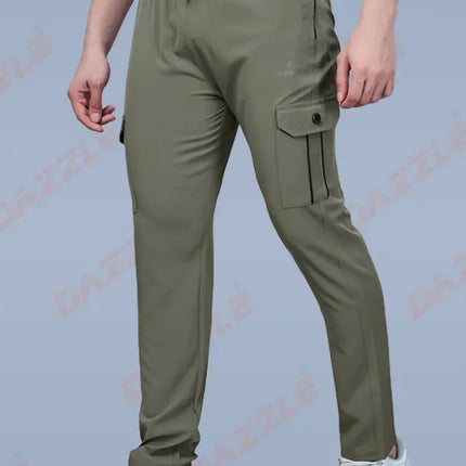 Person wearing olive green cargo pants on a gray background