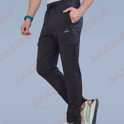 Person wearing black cargo pants with a light gray background