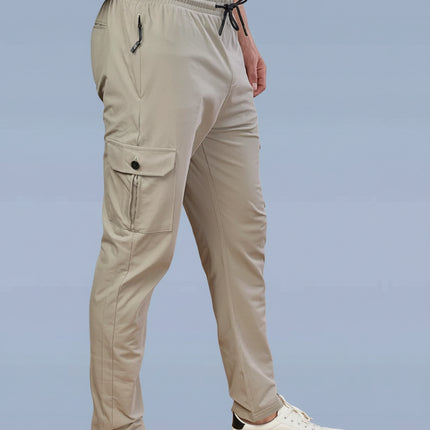 Beige pants worn by a person on a light blue background with Dazzle Sports Wear brand logo.