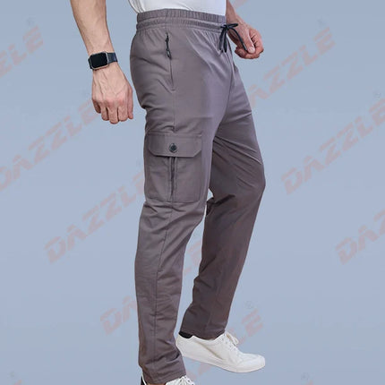 Person wearing gray cargo pants on a light blue background with 'Dazzle' branding.