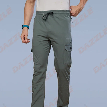 Person wearing gray cargo pants on a light blue background