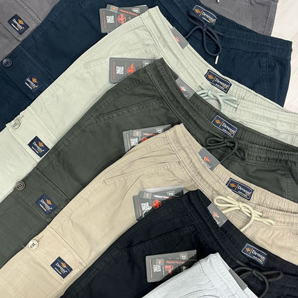Collection of men's pants in various colors with brand labels on a light background