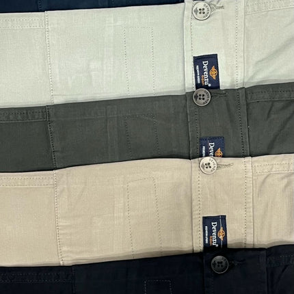 Close-up of a striped shirt with brand labels on buttons