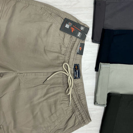 Brown shorts with tags on a light wooden surface