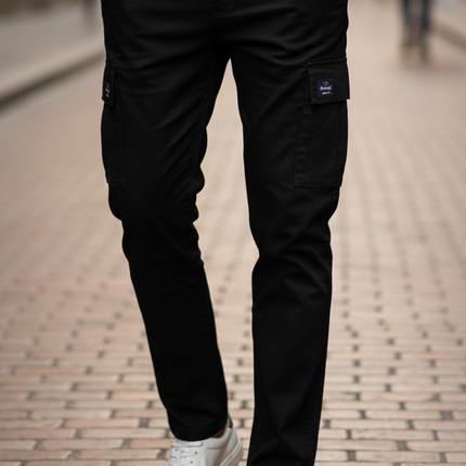 Man wearing a white sweater and black pants on a street.